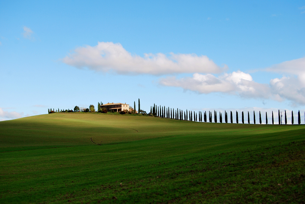 Tuscan countryside, with an Italian villa pictured in the distance