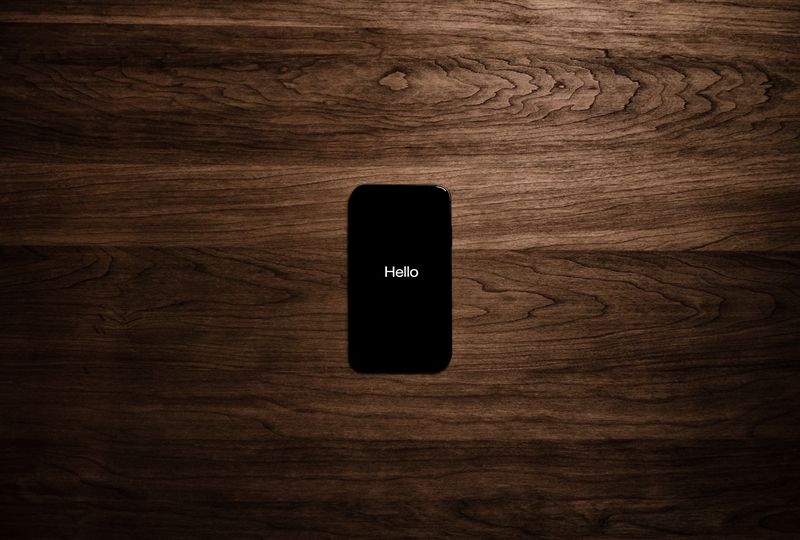 Black phone with white text hello