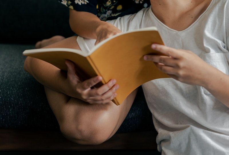 couple smiling and reading book