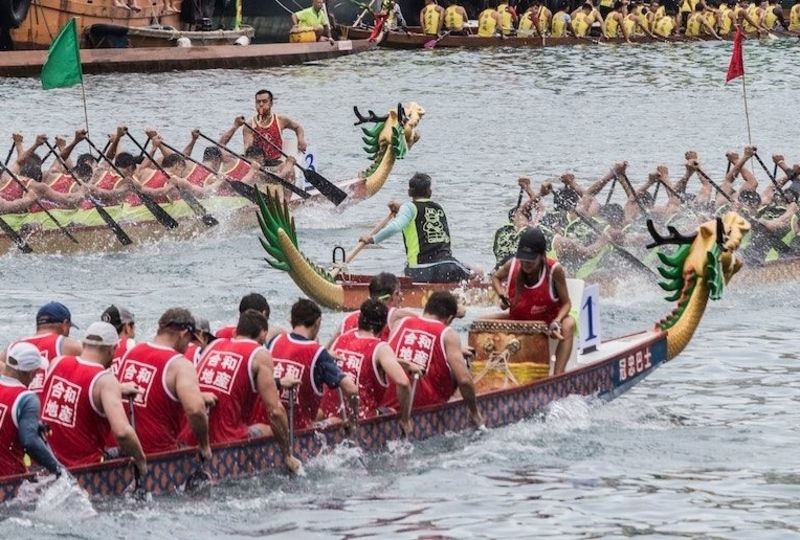 Three teams of Dragon Boat racers competing
