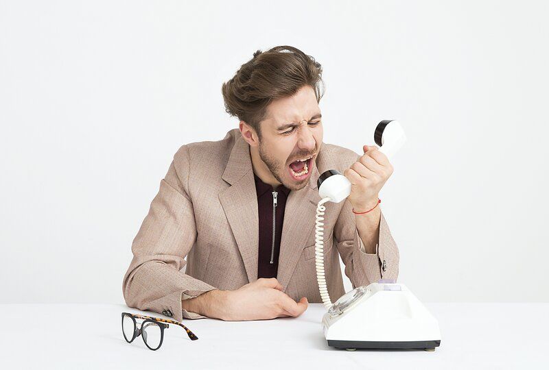 man yelling into the phone