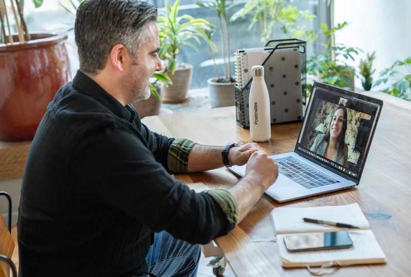 two people having a virtual video call on laptops and having a conversation