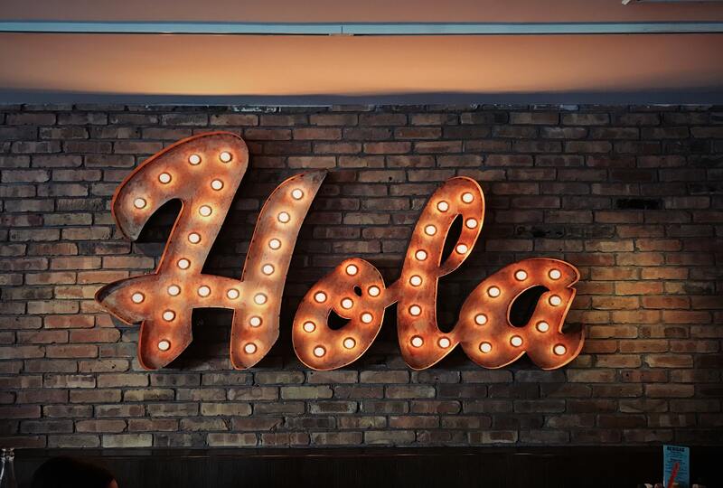 Hola written in lights on a wall