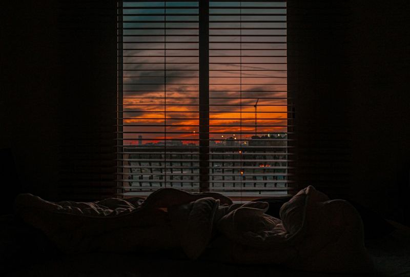 evening sunset cityscape seen through window of dark room