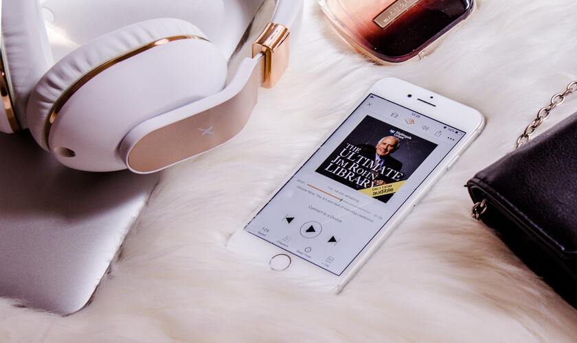 Audiobook on white iphone with white earphones