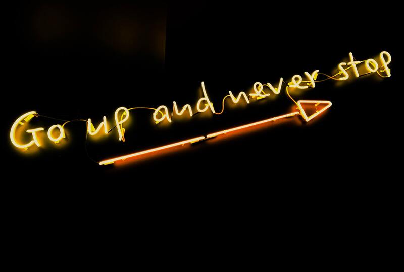 Go up and never stop written in LED lights