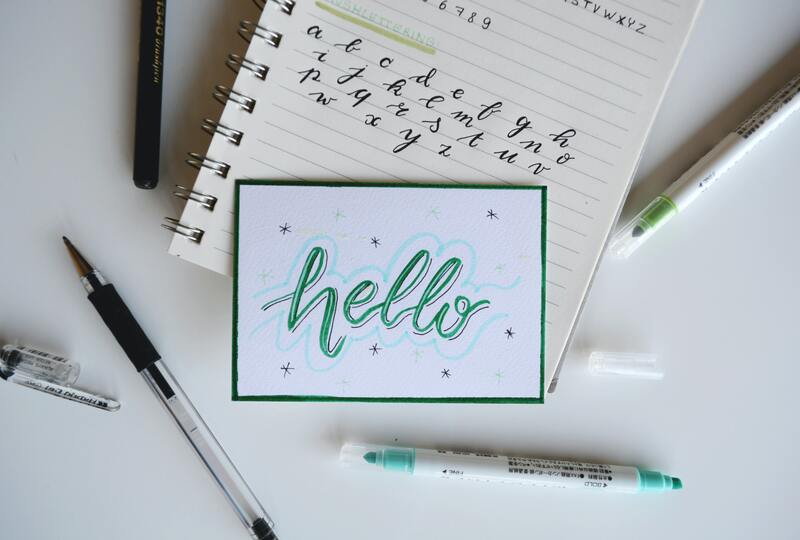 Hello in cursive on a notebook