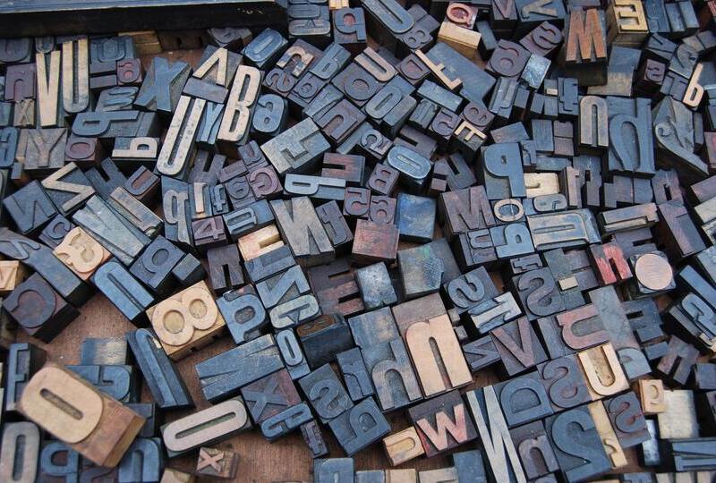Cast metal type pieces of varying letters