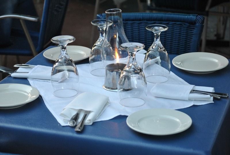 Clean restaurant table with a candle and blue table cloth