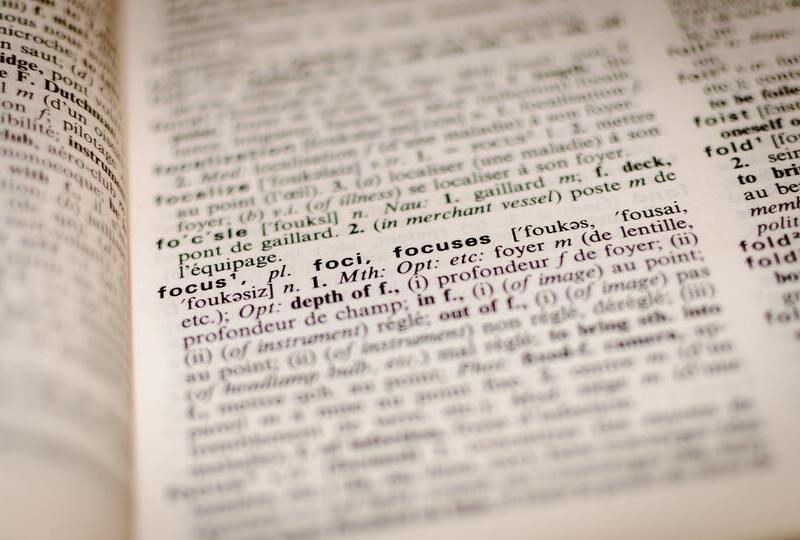 An open dictionary with the word 'focus' in focus