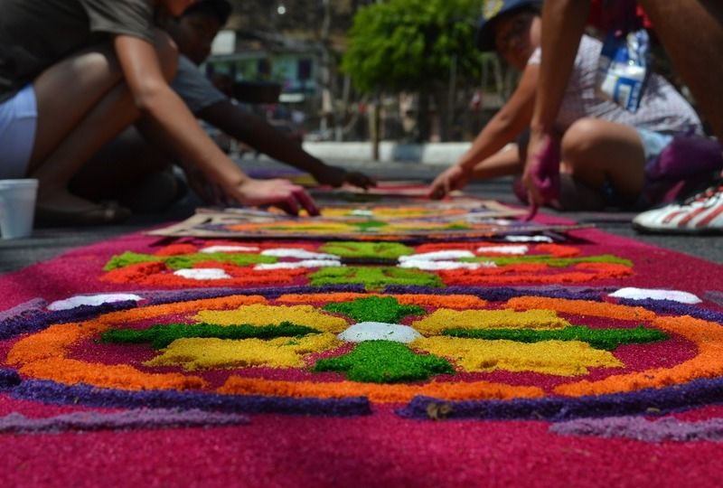 Guatemalan children make images on the street with flowers