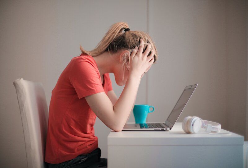 frustrated woman looking at a computer