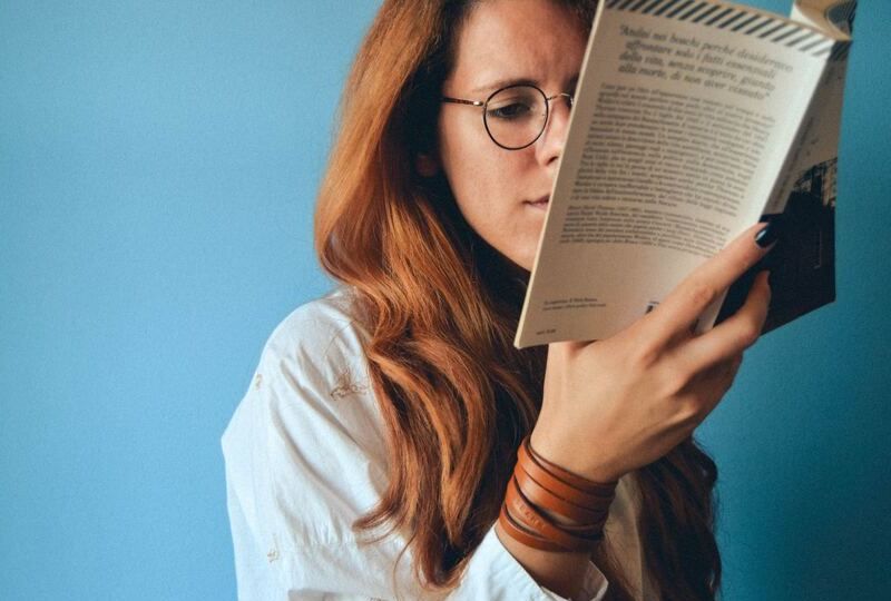 A picture of a young woman reading a book