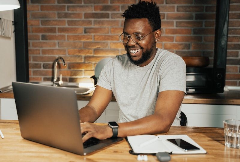 Man working on laptop happily
