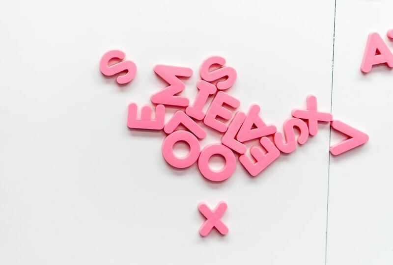 Pink magnet letters on a refrigerator