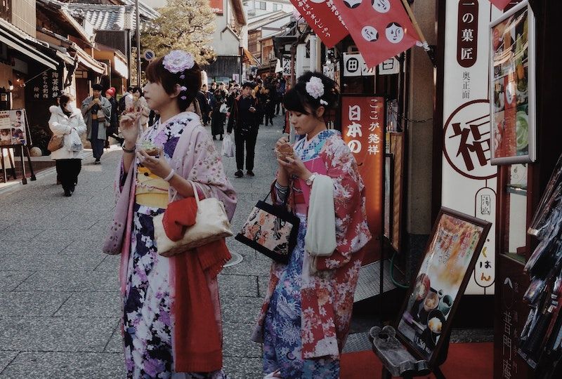 Two Women In Yukata Near Market