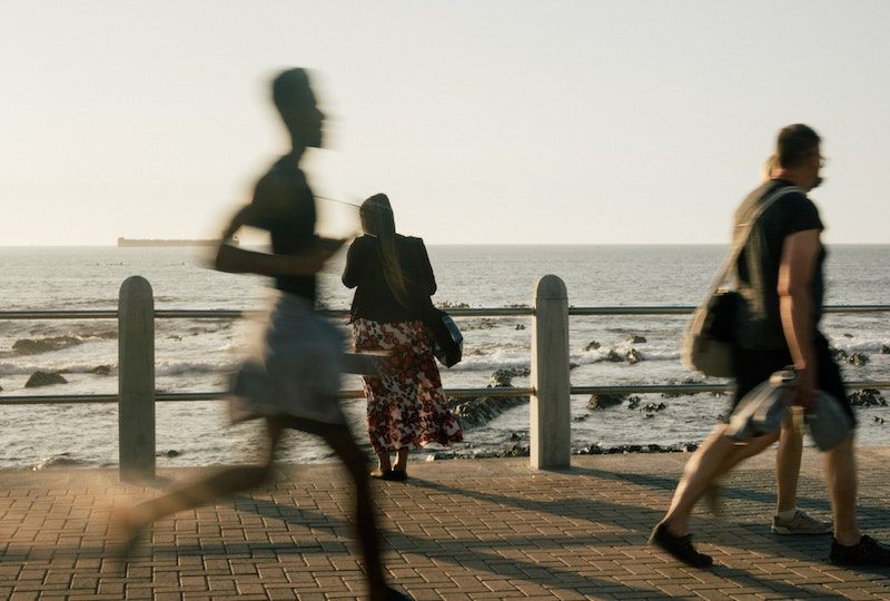 People walking along the beach.