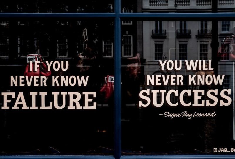 A window with a decal that says 'If you never know failure, you will never know success'
