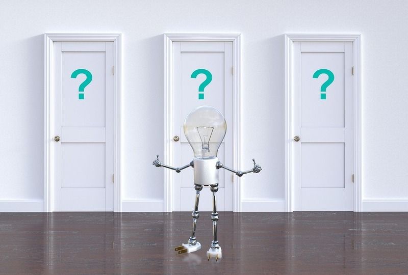 A personified lightbulb standing in front of three doors with question marks on them