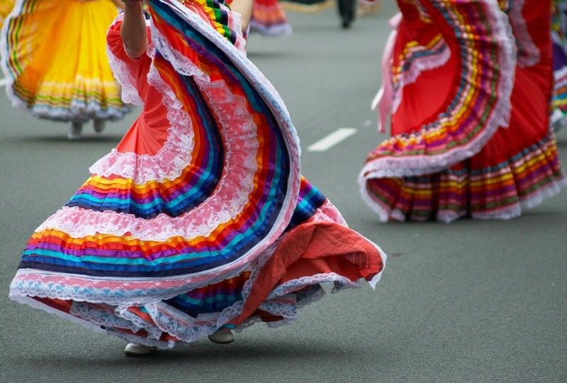Mexican woman in a red skirt twirls