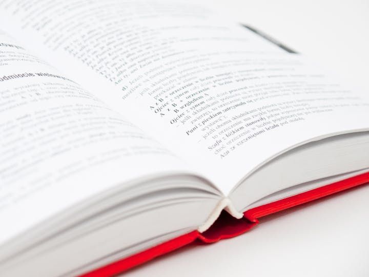 Dictionary book open on table.