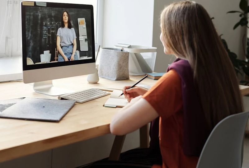 woman talking to another woman through video chat learning english