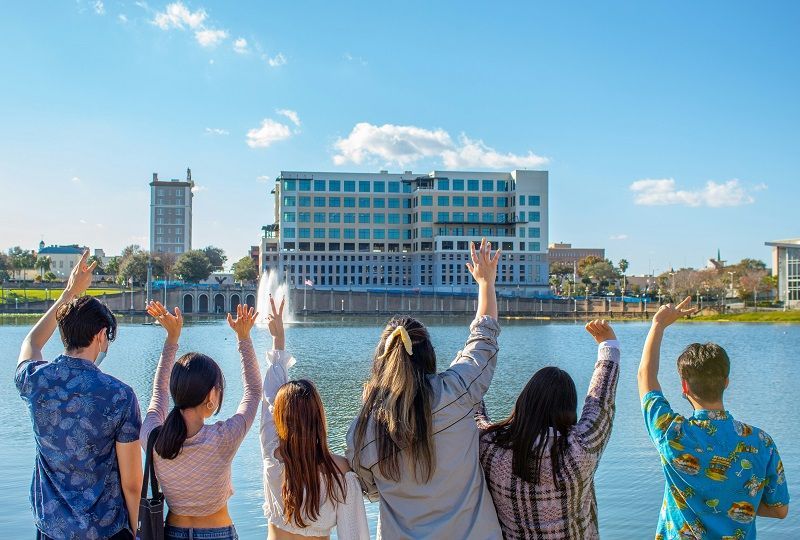 a group of people waving across a river