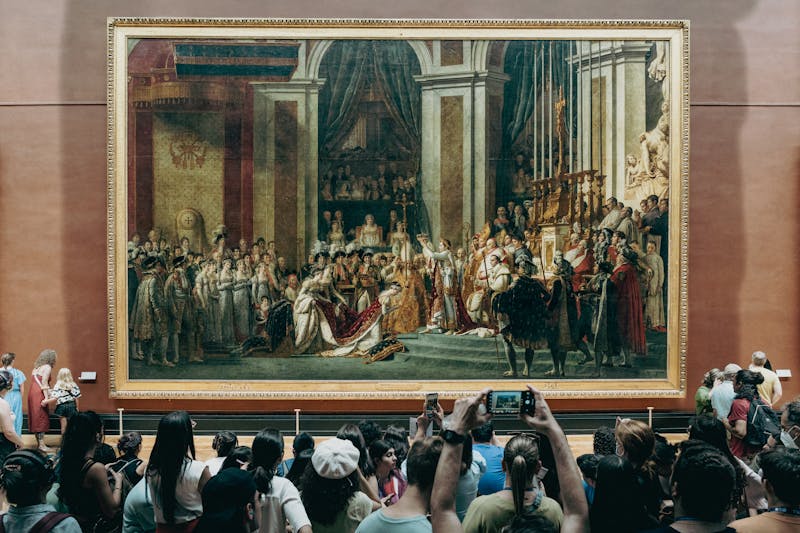 Tourists taking photos of a Napoleon painting.