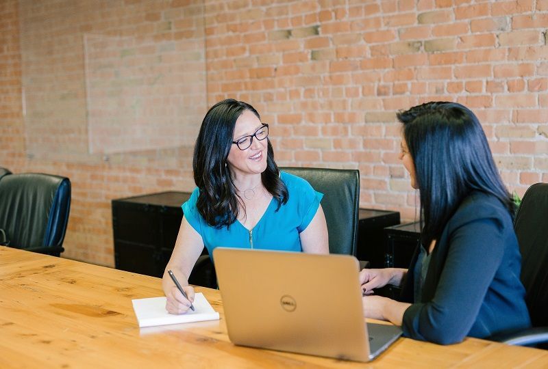 two women having a conversation at work