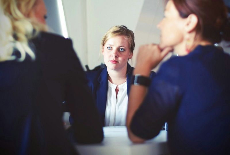 woman being interviewed by two other women