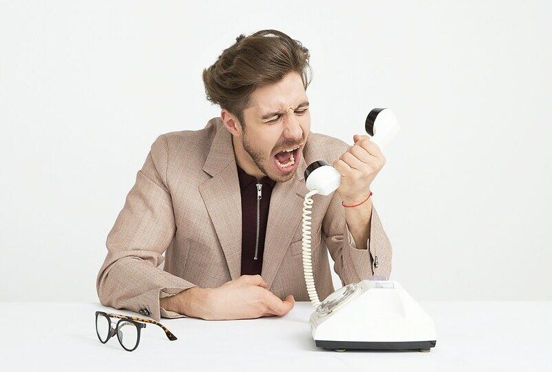 A man screaming into a phone