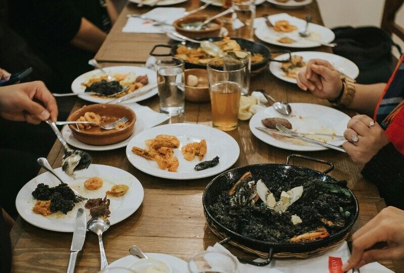 A table full of food, including paella