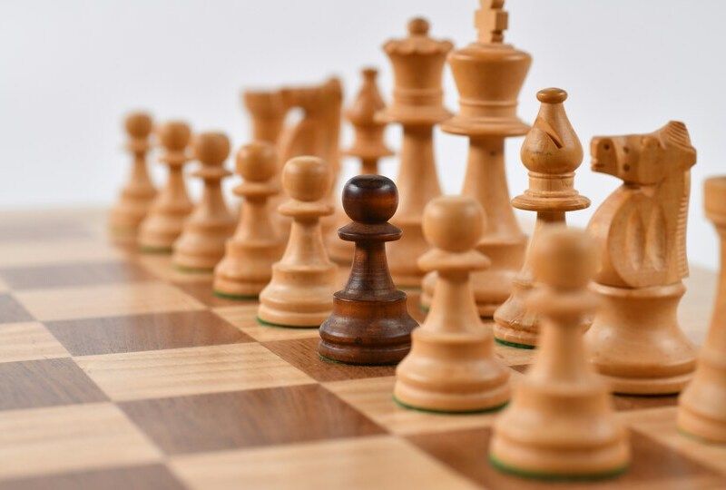 A chess board where one piece is a different color