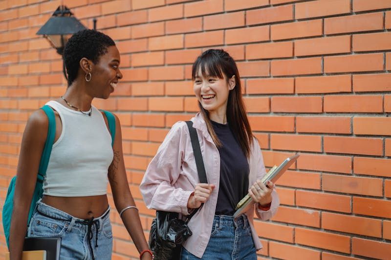 Two students walking and talking together.